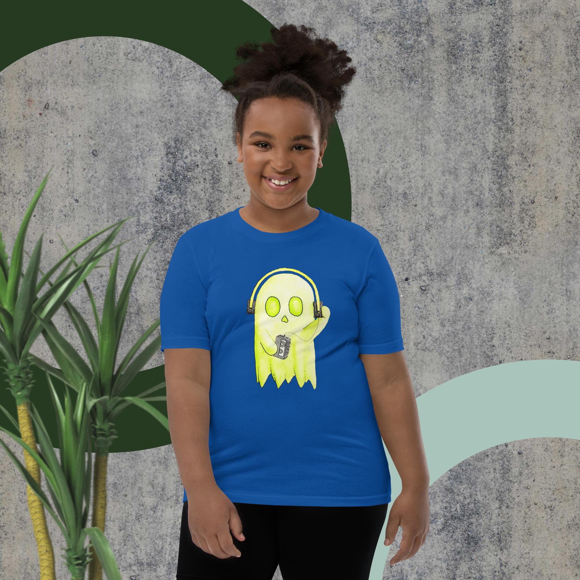 A child wearing a t-shirt with artwork of a ghost wearing headphones listening to music.